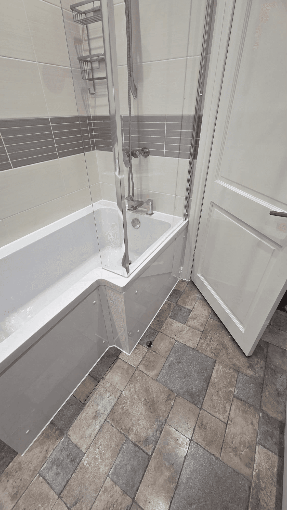 Completed bathroom with tiled bath surround