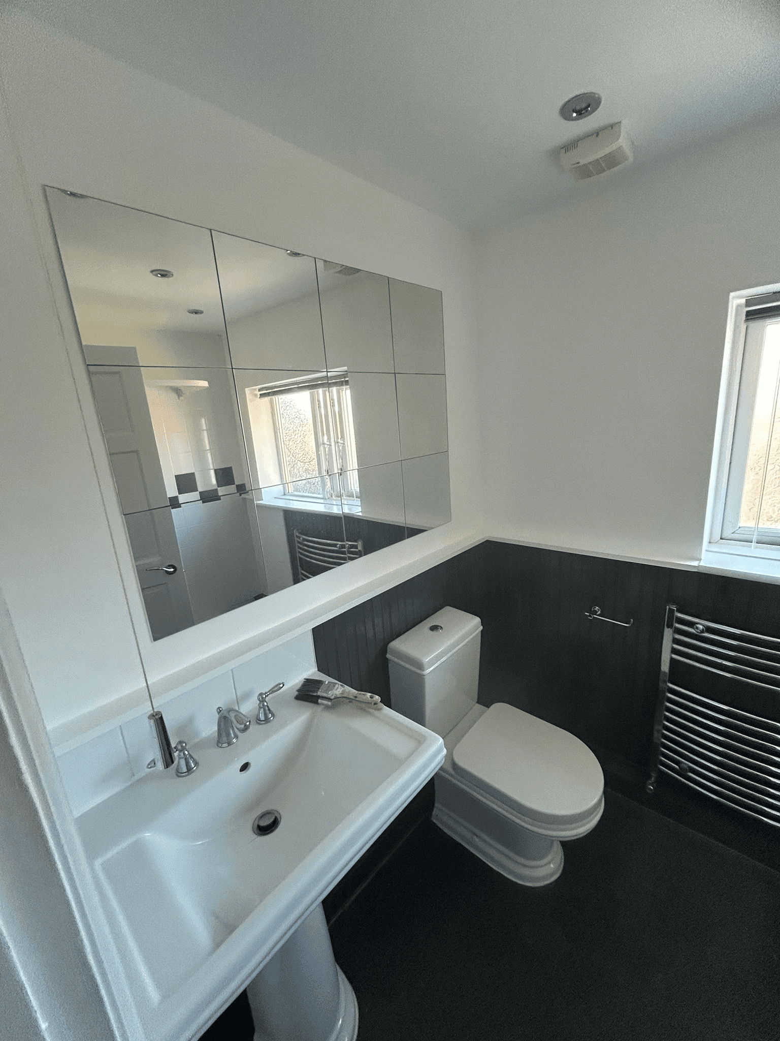 Completed bathroom with dark feature tiles