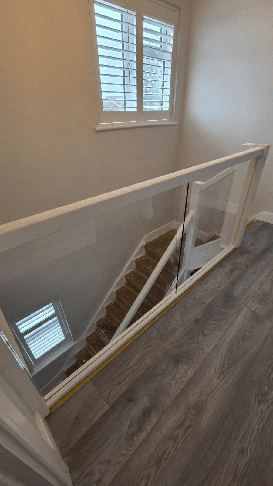 Glass staircase balustrade landing top view