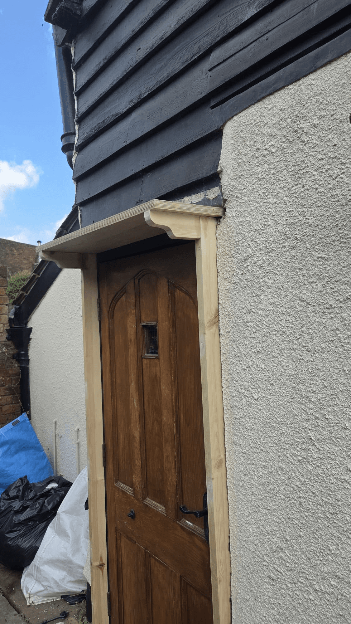 Solid wooden door with rendered surround