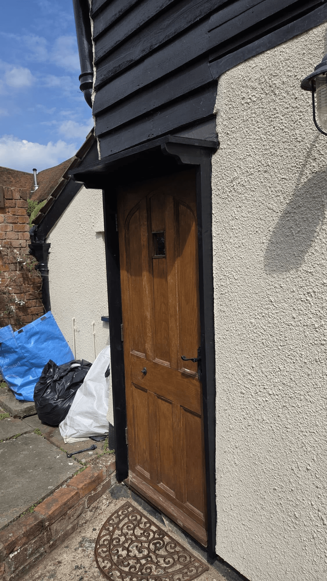 Wooden front door with black cladding