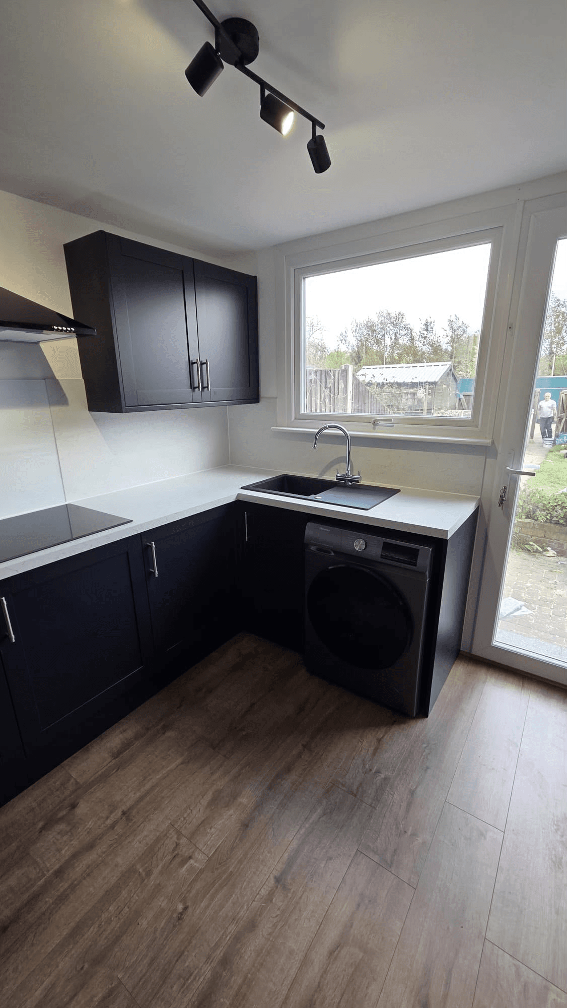 Dark kitchen installation with integrated appliances