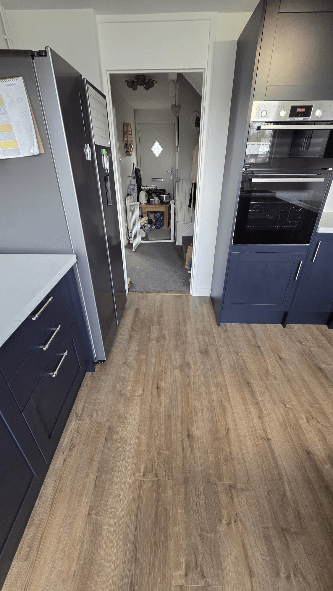 Completed navy kitchen with American fridge