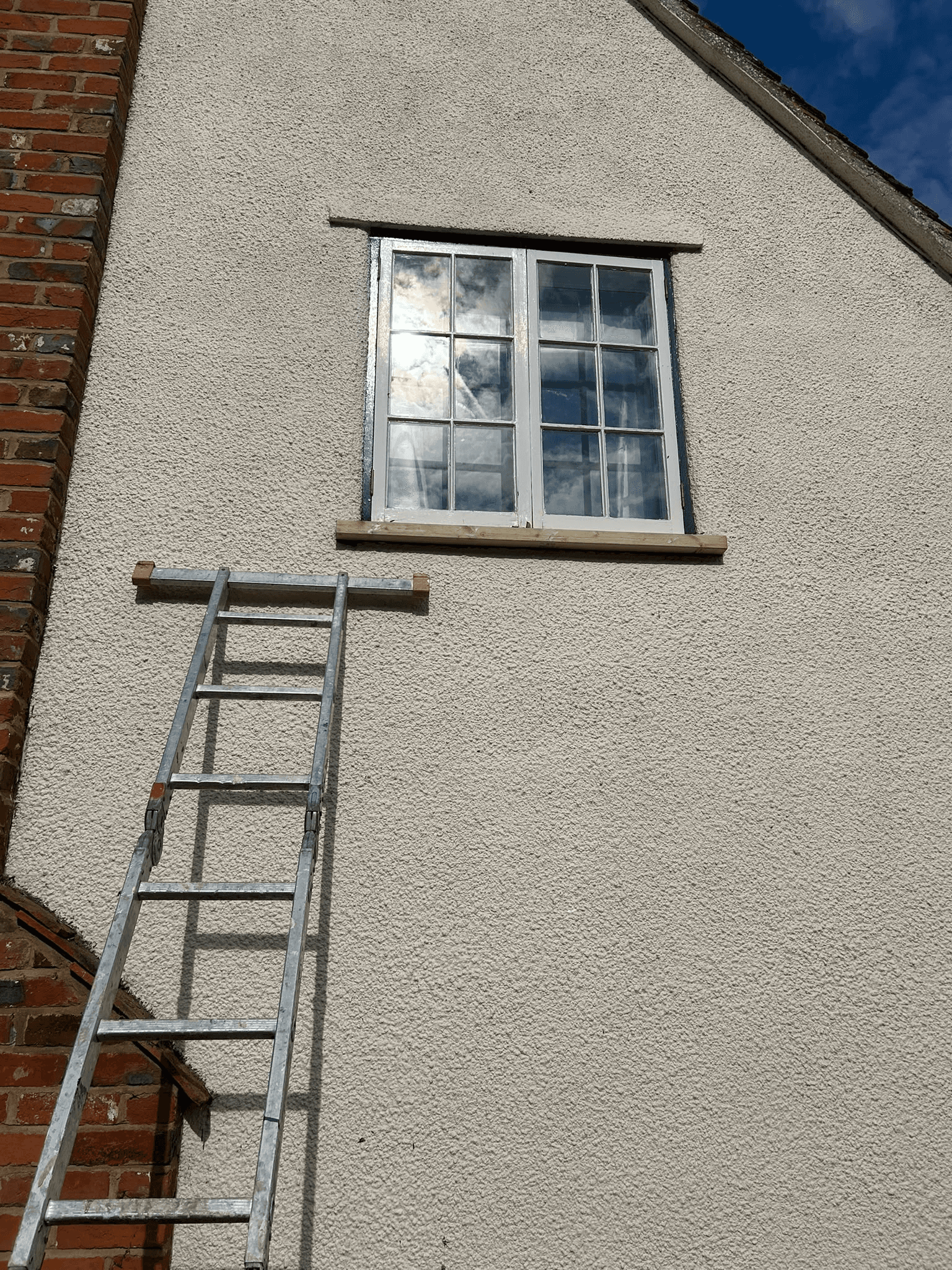 Window installation on rendered exterior