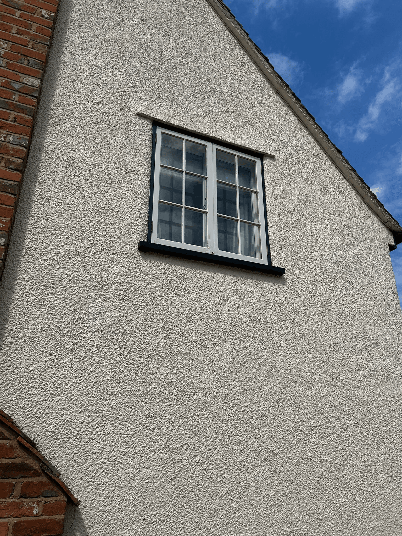 Completed window in rendered exterior wall